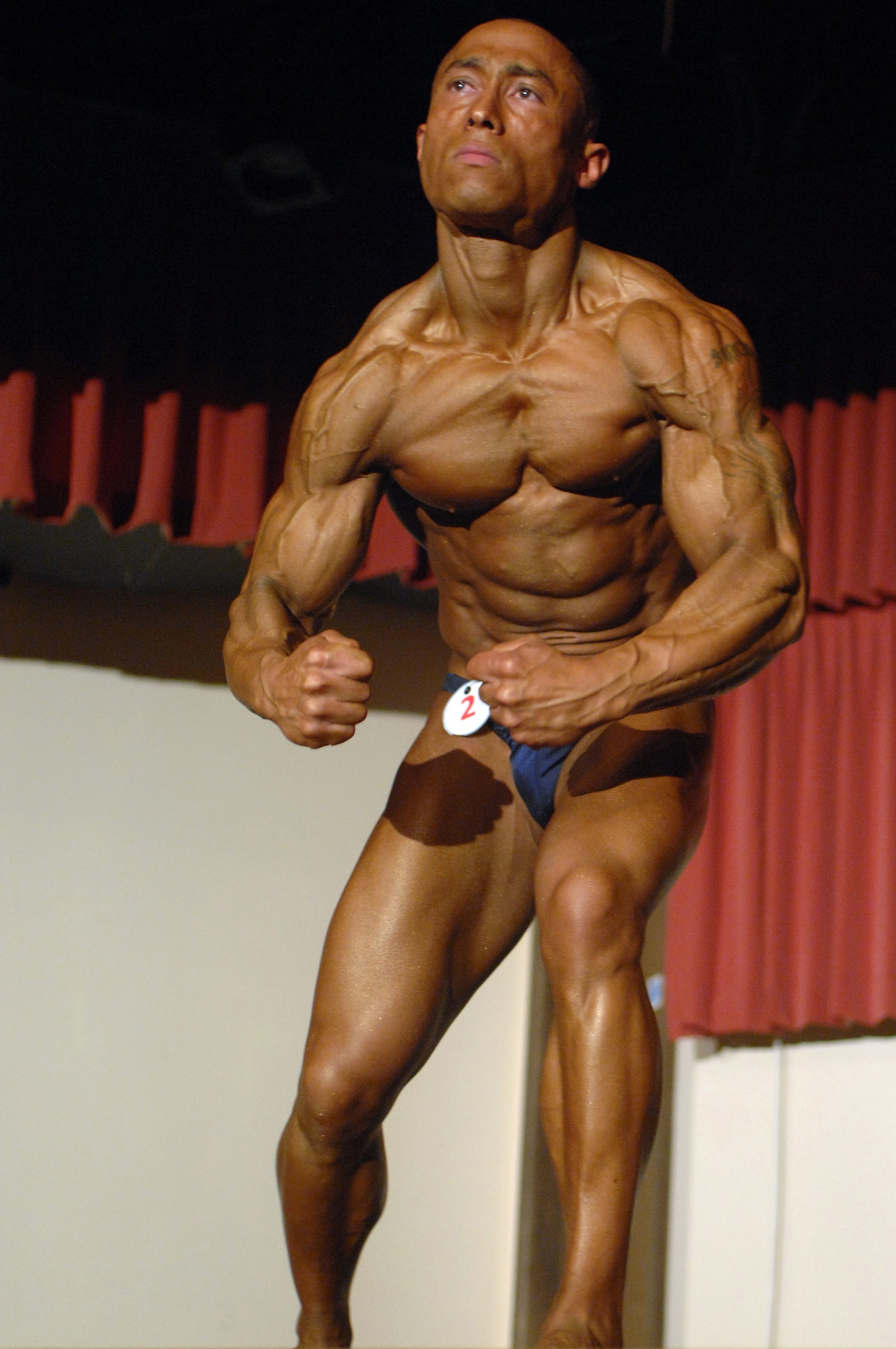 RAF MILDENHALL, England – Staff Sgt. Juan Lord, RAF Alconbury, gives the audience his “most muscular” pose during the Ultrabodies IX bodybuilding competition June 28. (U.S. Air Force photo by Senior Airman Teresa M. Hawkins)