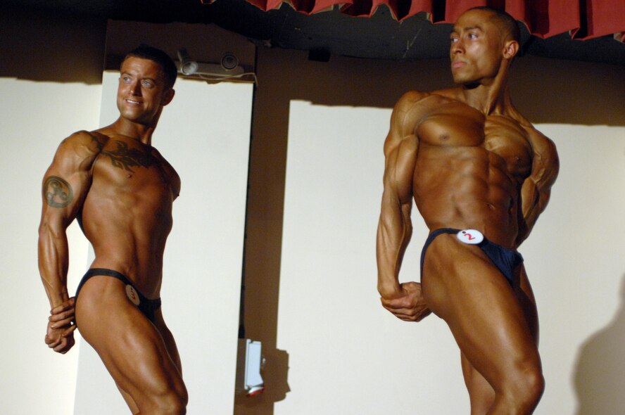 RAF MILDENHALL, England – Senior Airman Justin Schomig (left), RAF Mildenhall, and Staff Sgt. Juan Lord, RAF Alconbury, show off their triceps during the Ultrabodies IX bodybuilding competition June 28. (U.S. Air Force photo by Senior Airman Teresa M. Hawkins)