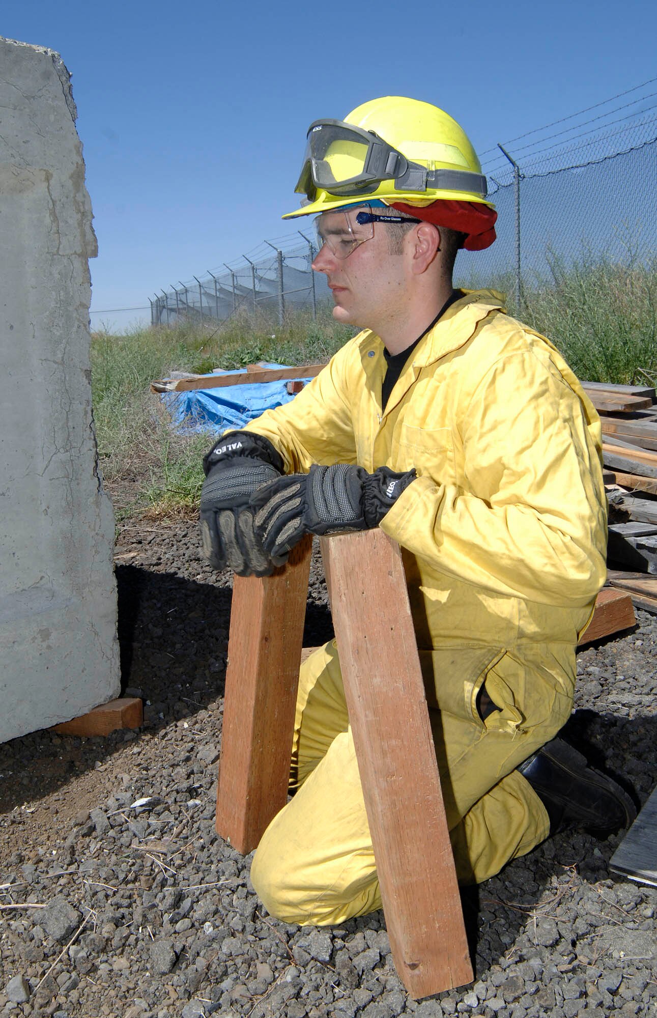 FAIRCHILD AIR FORCE BASE, Wash. – Airman 1st Class Christopher Sparks, 92nd Civil Engineer fireman apprentice, holds two planks b cribbing for the heavy lift/air bag procedure at the Extrication Spokane 2008 training. This process helps lift the vehicle by using the integrated teams of various firemen learned advanced auto extrication techniques. (U.S. Air Force photo/Staff Sgt. JT May III)