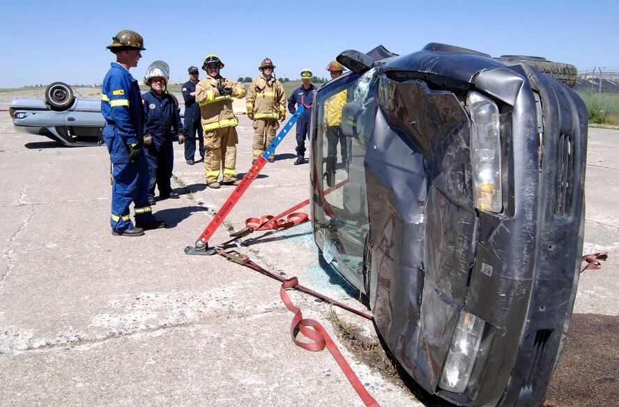 FAIRCHILD AIR FORCE BASE, Wash. – A firefighters team prepares to use the Tension Buttress System at the Extrication Spokane 2008. The system is used to help stabilize the rails in the car from collapsing. The integrated teams of various firemen learned advanced auto extrication techniques. The training consisted of two ten-hour days with eight different objectives. (U.S. Air Force photo/Staff Sgt. JT May III)