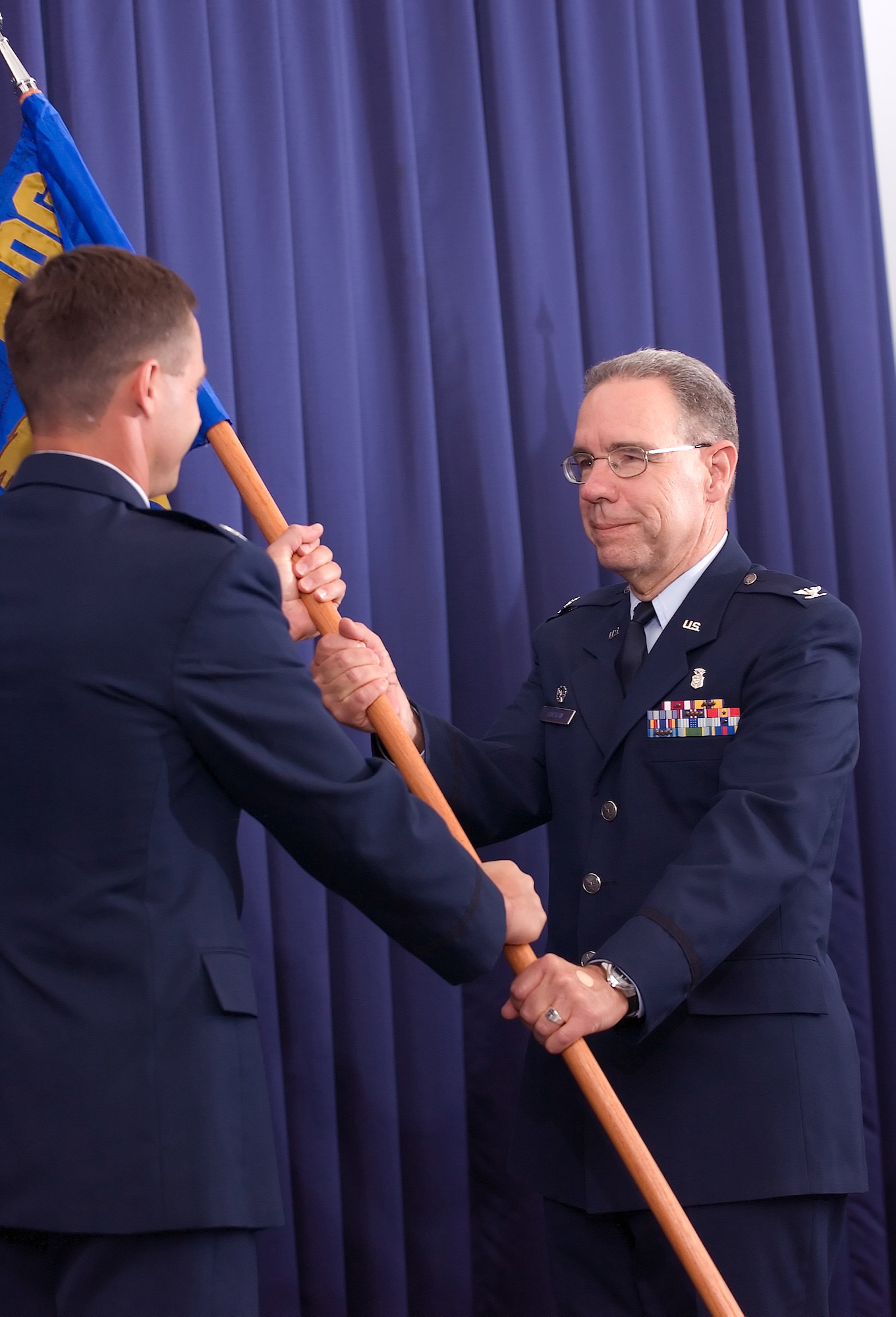 DOVER AIR FORCE BASE, Del. -- (Right to left) Col. James Cocklin, 436th Dental Squadron commander, accepts the dental squadron guidon from Col. Steven Harrison, 436th Airlift Wing commander, July 2 during an assumption-of-command ceremony. The 436th DS, deactivated in 2002, was reactivated to meet new Air Force guidlines. (U.S. Air Force photo/Jason Minto)