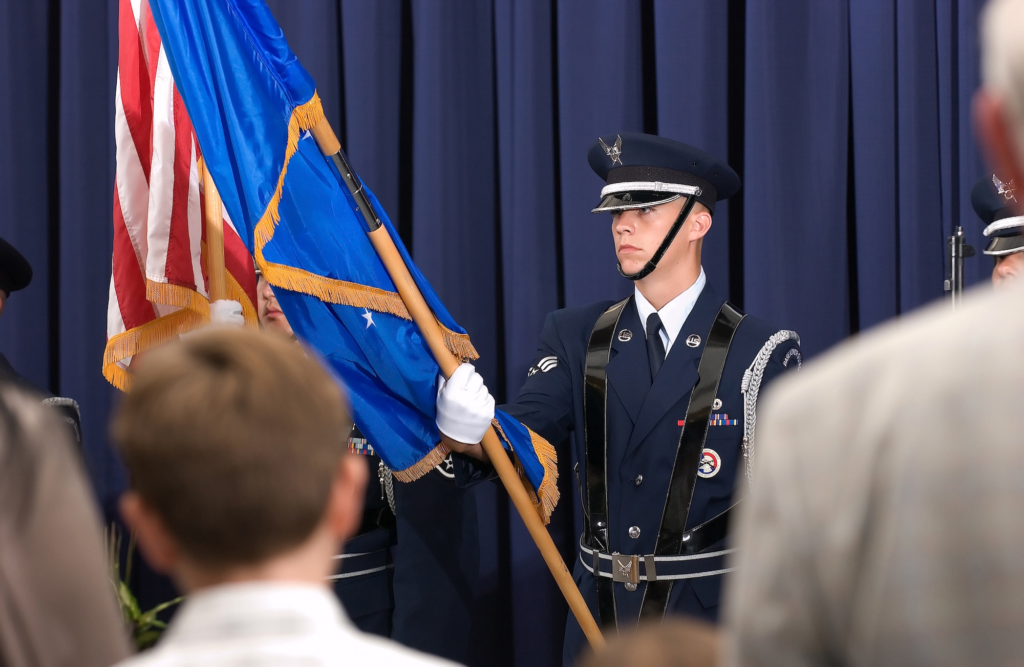 DOVER AIR FORCE BASE, Del. -- Senior Airman Casey Mulkey, 436th Aerial Port Squadron and DAFB honor guard member, presents the Air Force Flag during the National Anthem July 2 at the joint 436th Aerospace Medicine and 436th Dental Squadron assumption-of-command ceremony. The 436th Dental Squadron was reactivated after a six-year absence from the 436th Airlift Wing. (U.S. Air Force photo/Jason Minto)