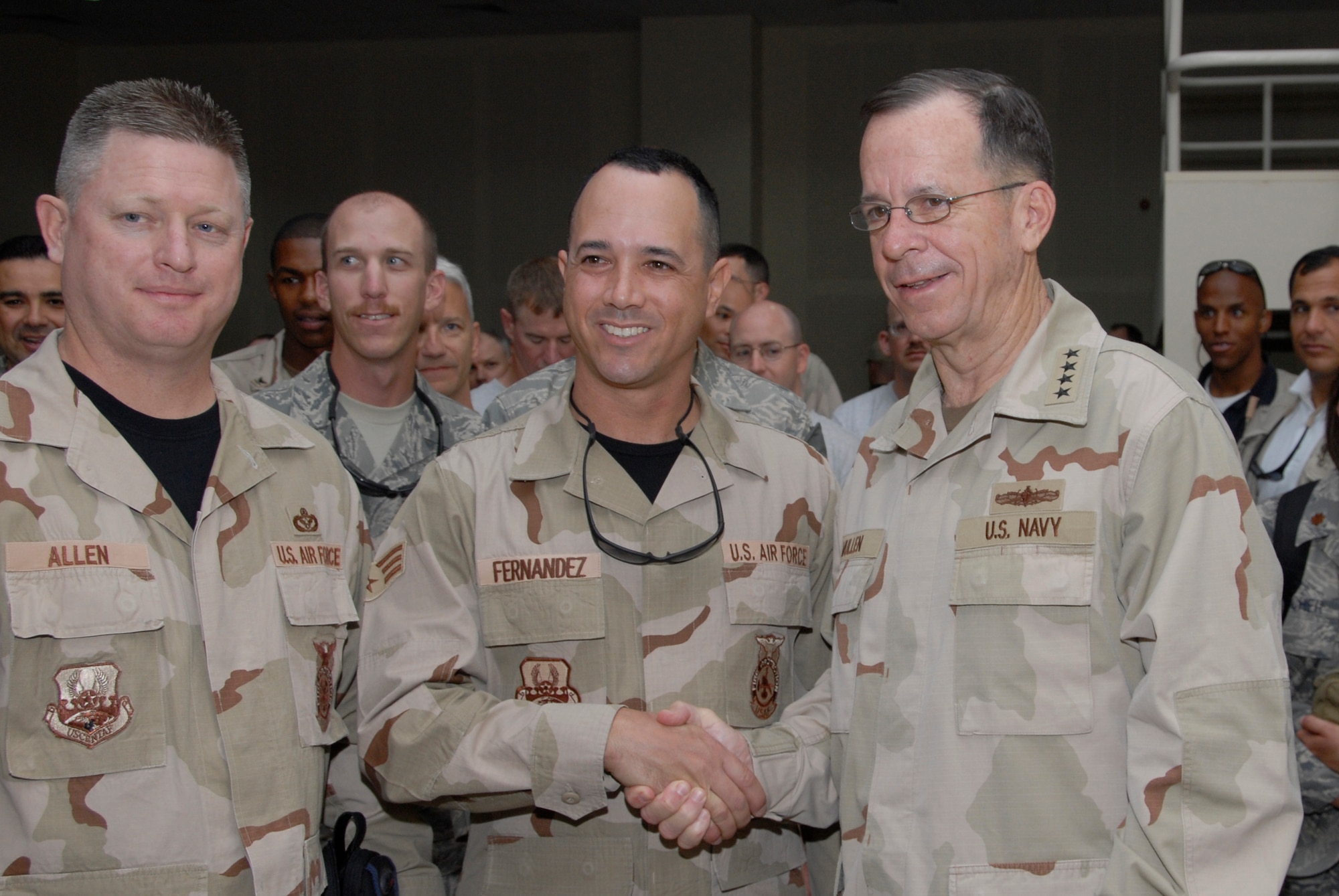 SOUTHWEST ASIA -- Navy Admiral Mike Mullen, chairman of the Joint Chiefs of Staff, poses for a photo with Senior Airman Eric Fernandez and Senior Master Sgt. Todd Allen, fire fighters deployed to the 386th Expeditionary Civil Engineer Squadron, July 7, 2008, at the theatre on an air base in the Persian Gulf Region. Admiral Mullen is on a seven-day, summer troop visit and United Service Organizations tour. (U.S. Air Force photo/Staff Sgt. Patrick Dixon)
