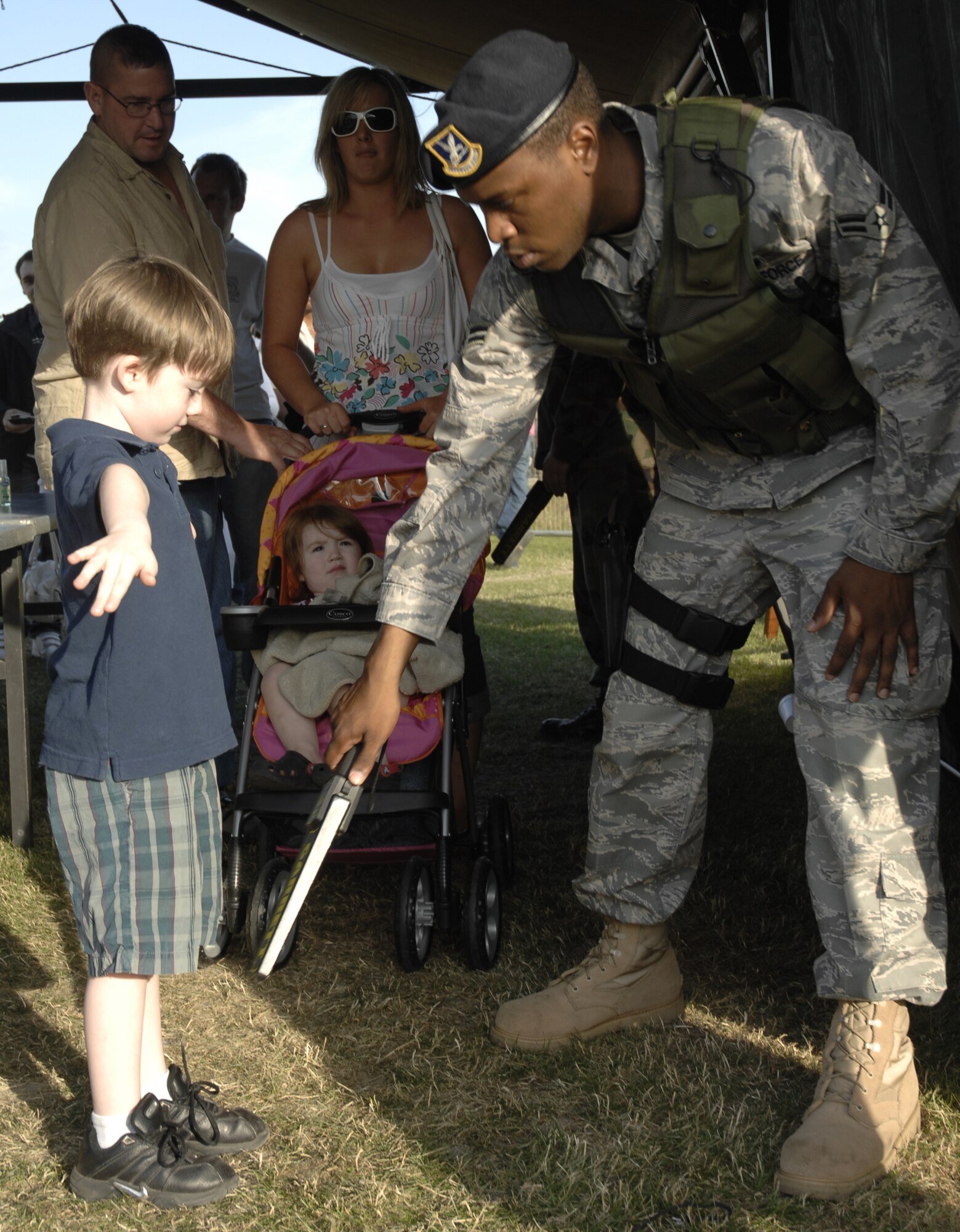 Airman 1st Class Stephen Singleton, 48th Security Forces Squadron, searches a young member of the Air Force family before he enters the Fourth of July celebration. Everyone entering the grounds was search for contraband before entering. (U.S. Air Force photo by Tech. Sgt. J. LaVoie)
