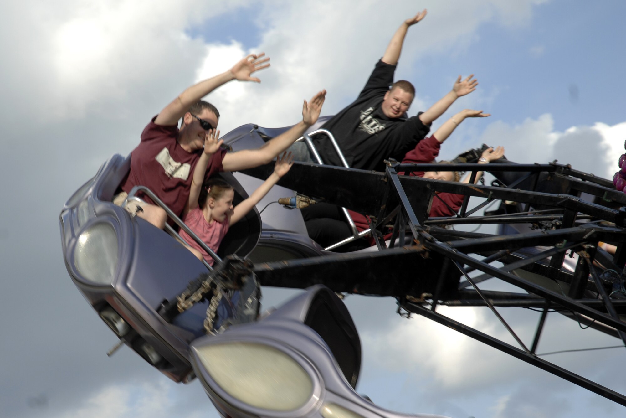 Revelers throw their hands in the air while on a carnival ride during the Fourth of July celebration at RAF Feltwell. (U.S. Air Force photo by Tech. Sgt. J. LaVoie)