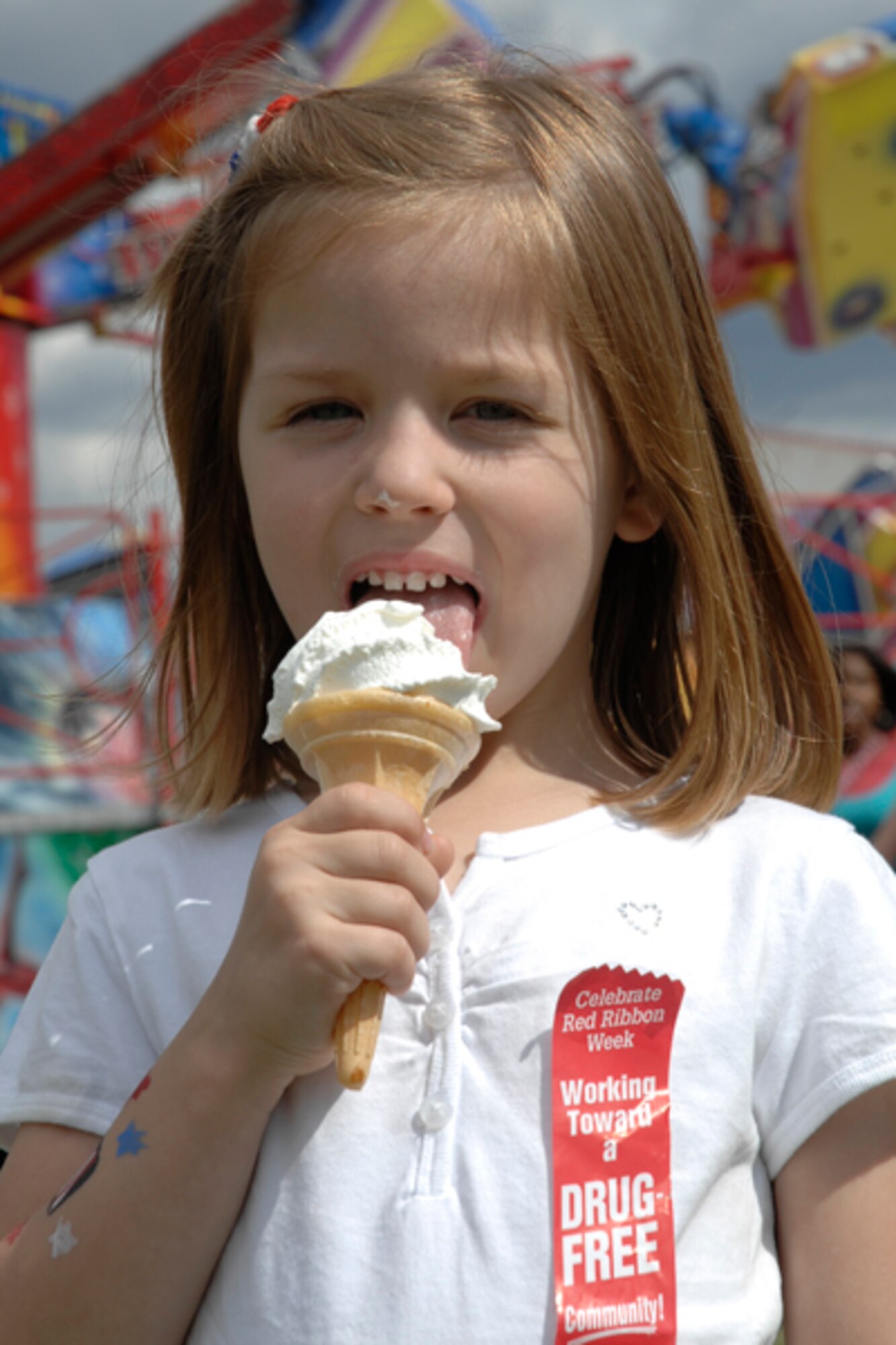 Nicole Schultz enjoys an ice cream cone during Fourth of July festivities at RAF Feltwell. Ice cream is just one of the many favorites that were available for consumption.  (U.S. Air Force photo by Senior Master Sgt Thomas Wood)