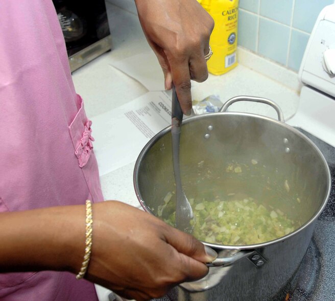 OSAN AIR BASE, Republic of Korea -- Master Sgt. Tonya Boone, 51st Operations Support Squadron senior watch supervisor, stirs onions and bell peppers during the Cajun cooking class held July 1 at the Airman and Family Readiness Center. The vegetables, along with celery, are considered Cajun cuisine’s holy trinity by many renowned chefs. (U.S. Air Force photo/Staff Sgt Lakisha Croley)
