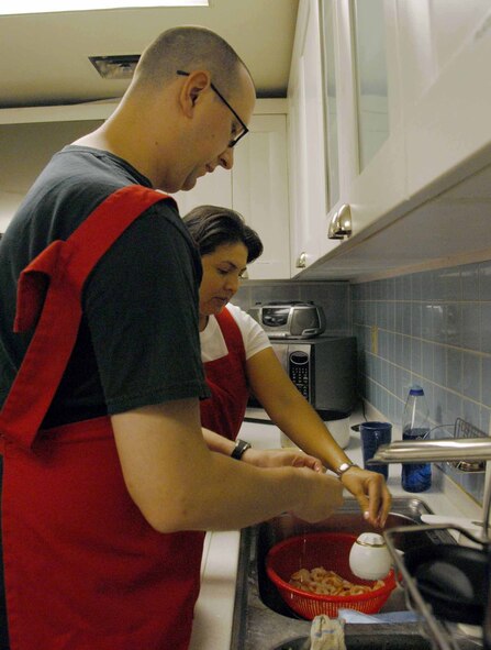 OSAN AIR BASE, Republic of Korea -- (From left to right) Senior Airman Matthew Garrett, 51st Munitions Squadron conventional support member, and Staff Sgt. Jobette Rosati, 51st Fighter Wing military justice paralegal, peel shrimp as part of the  Cajun cooking class held July 1 at the Airman and Family Readiness Center. The Cajun cooking class is just one of several cooking class hosted by the AFRC. (U.S. Air Force photo/Staff Sgt Lakisha Croley)