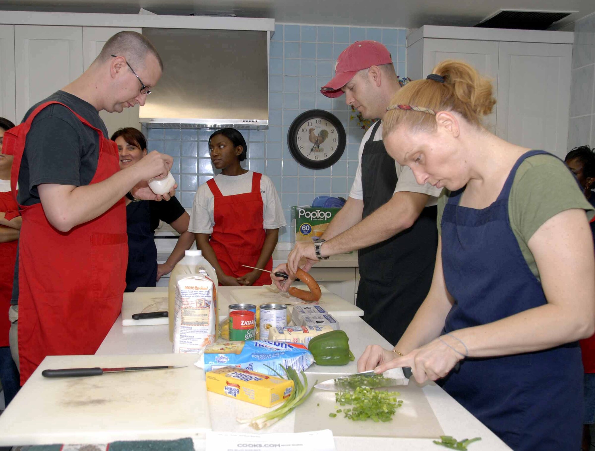 OSAN AIR BASE, Republic of Korea --Team Osan members work together to prepare a stew and other delights during the Cajun cooking class held July 1 at the Airman and Family Readiness Center. The AFRC hosts several different classes and activities such as cooking classes, volunteer opportunities and cultural field trips. (U.S. Air Force photo/Staff Sgt Lakisha Croley)
