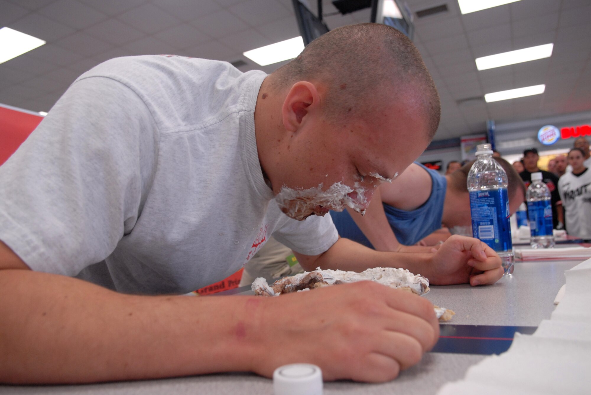 KUNSAN AIR BASE, Republic of Korea— Senior Airman Andrew Nickeson, 8th Civil Engineer Squadron, competes in the pie eating contest here July 4. The contest was just one of the many actives held here to celebrate Independence Day.( US Air Force Photo by: Senior Airman Angela Ruiz) 