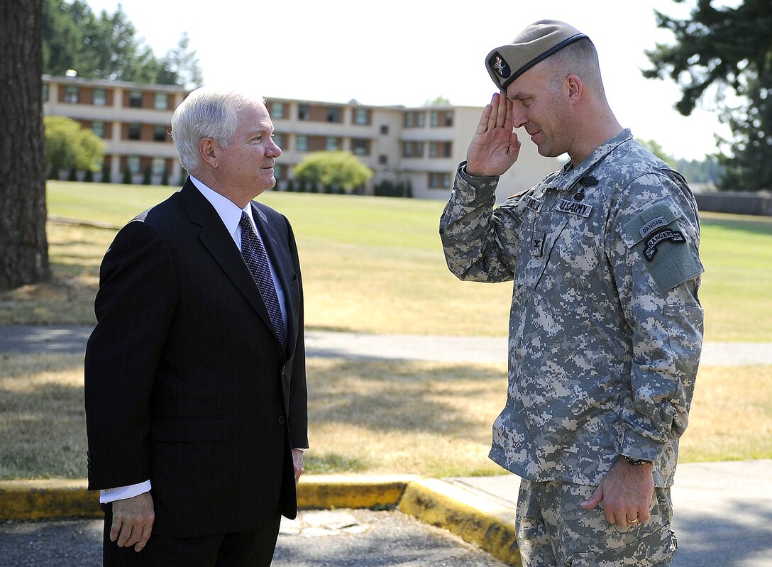 Defense Secretary Robert M. Gates receives a salute from U.S. Army Col. Mike Kurilla, commander, 2nd Battalion, 75th Ranger Regiment, while on a tour of the facilities on Fort Lewis, Wash., July 7, 2008.  