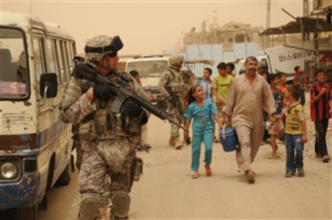 U.S. Army soldiers from the 432nd Civil Affairs Battalion and the 926th Engineer Brigade Combat Team conduct assessments in the Sadr City district of Baghdad, Iraq, on July 2, 2008.  The soldiers, assigned to Task Force Gold in conjunction with Task Force Regulars, are conducting site assessments in support of revitalization projects in the area.  