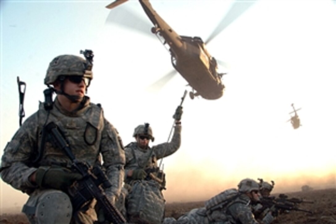 U.S. Army 2nd Lt. Kurt Shingledecker gets his bearings after leaving a helicopter while participating in an air assault mission conducted around the city of Mahmudiyah, Iraq, July 3, 2008. The soldiers are assigned to the 101st Airborne Division, 3rd Brigade,187 Infantry Regiment. 