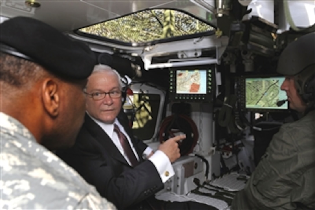 Defense Secretary Robert M. Gates and Army Col. Harry Tunnell look into a Stryker Transport vehicle while on a tour of the 5th Brigade, 2nd Infantry Division on Fort Lewis, Wash., July 8, 2008. Tunnell is the commander, 5th Brigade, 2nd Infantry Division.  
