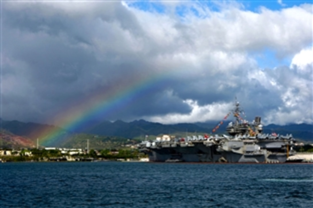 A rainbow arches near the aircraft carrier USS Kitty Hawk while it is moored at Pearl Harbor, July 4, 2008. The USS Kitty Hawk is making its first U.S. port call in more than 10 years. The ship will participate in Rim of the Pacific 2008 with units from the United States, Australia, Chile, Canada, Japan, the Netherlands, Peru, South Korea, Singapore and the United Kingdom.  