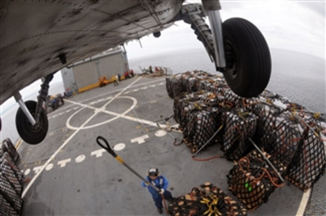 A U.S. Navy sailor prepares to latch a cargo pendant to the underbelly of an HH-60H Seahawk helicopter while standing on the deck of the USNS Niagara Falls (T-AFS 3) that is underway off the coast of the Philippines prior to a humanitarian flight to Kalibo, Philippines, on June 29, 2008.  The Ronald Reagan Carrier Strike Group is providing humanitarian assistance and disaster relief to victims of Typhoon Fengshen, which struck the Philippines June 23, 2008.  