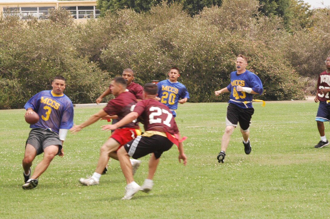 A blitz from Ceremonial Platoon’s defensive tackle forces Capt. Richard J. Fay, left, to scramble.