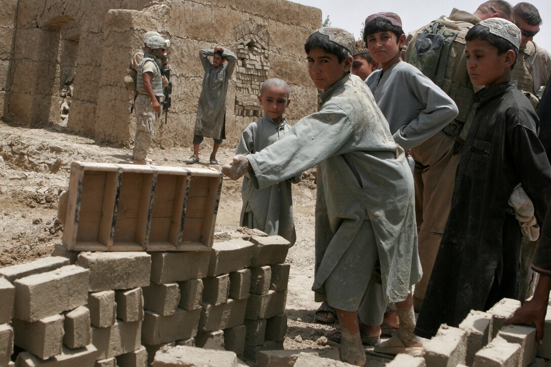 Citizens of the Garmsir city district lend a helping hand in the reconstruction effort in Helmand Province.