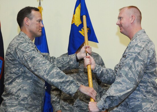 Col. Bret Klassen, 36th Maintenance Group Commander presents the 36th Maintenance Squadron guidon to Maj. Joseph Shirey signifying the change of command July 10 here. Major Shirey arrives here from the North Atlantic Treaty Organization Component Command Headquartes, Izmir, Turkey. (U.S. Air Force by Airman 1st Class Nichelle Griffiths)