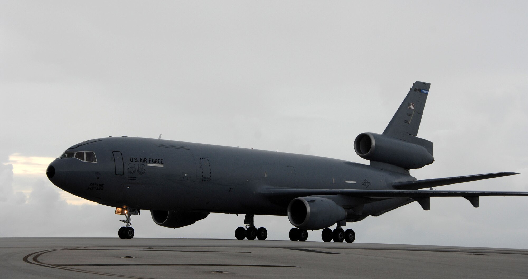 A U.S. Air Force KC-10 Extender waits for instructions to depart from a runway on Andersen Air Force Base, July 9. The KC-10, from Travis AFB, escorted six F/A-18's from Naval Air Station Lemoore, Calif.  The fighters used Andersen waypoint on their way to Royal Australian Air Force Base Tindal where they will participate in an exercise with the Australians. (U.S. Air Force photo by Airman 1st Class Courtney Witt)