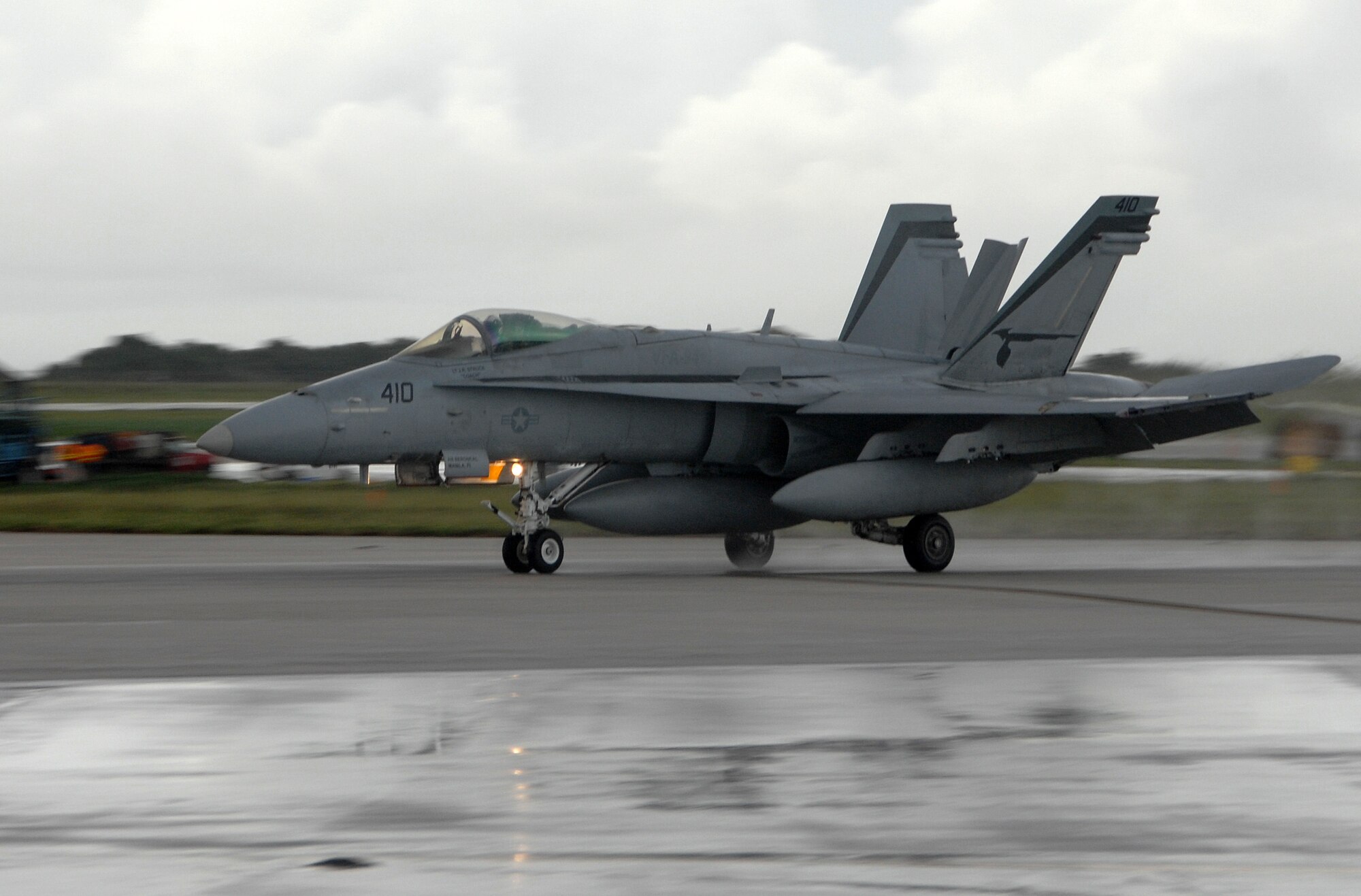 A U.S. Navy F/A-18 Hornet, from Strike Fighter Squadron 94 at Naval Air Station Lemoore, Calif., lands at Andersen Air Force Base July 9. The F/A-18 is a strike fighter aircraft flown by the Navy and Marine Corps.   Aircrews from 12 Hornets used Andersen as a resting point during their flight from California to Australia where they will participate in an exercise with the Australian Air Force.  (U.S. Air Force photo by Airman 1st Class Courtney Witt)