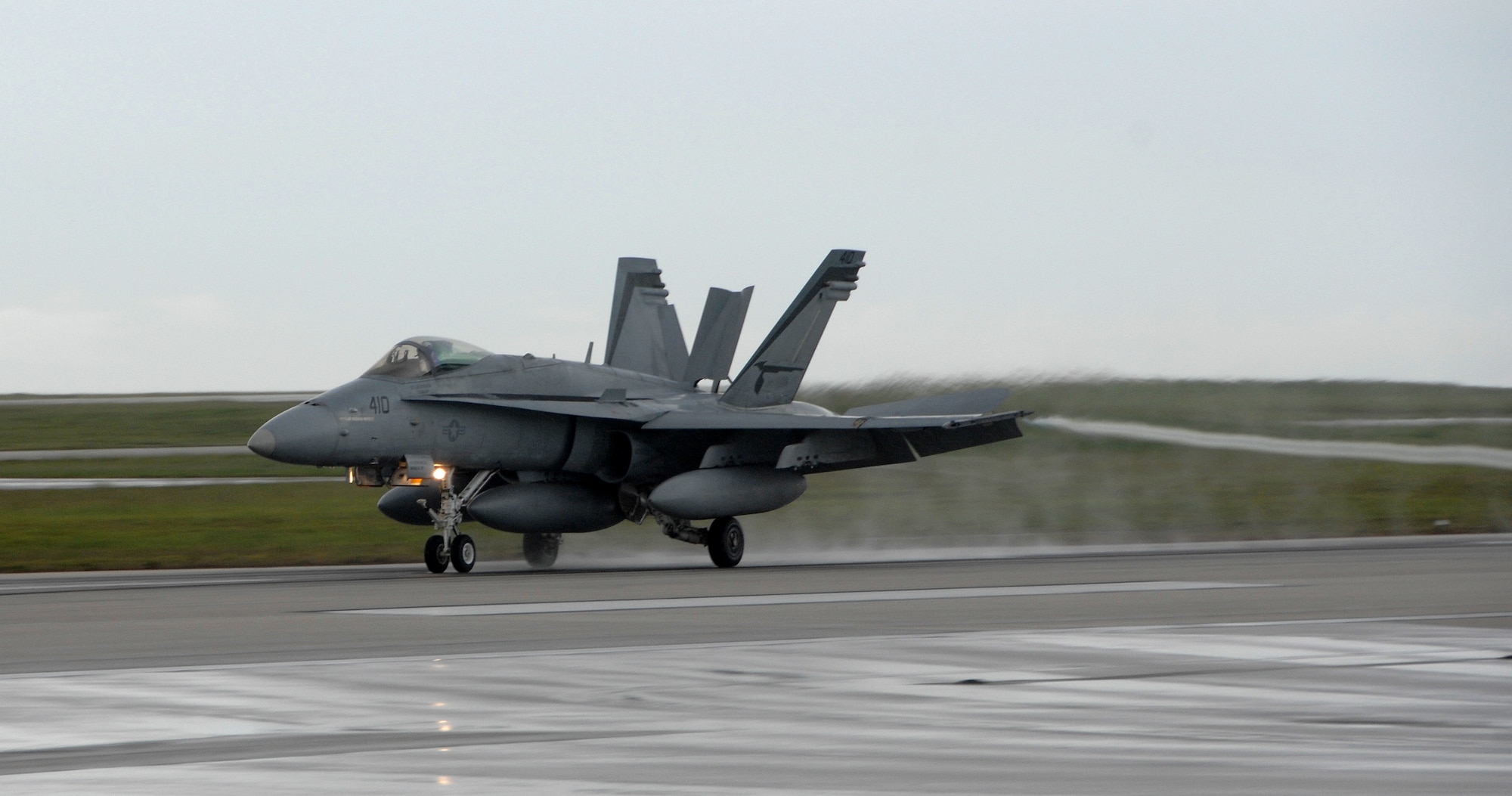 A U.S. Navy F/A-18 Hornet, from Strike Fighter Squadron 94 at Naval Air Station Lemoore, Calif., lands at Andersen Air Force Base July 9. The F/A-18 is a strike fighter aircraft flown by the Navy and Marine Corps.   Aircrews from 12 Hornets used Andersen as a resting point during their flight from California to Australia where they will participate in an exercise with the Australian Air Force.  (U.S. Air Force photo by Airman 1st Class Courtney Witt)