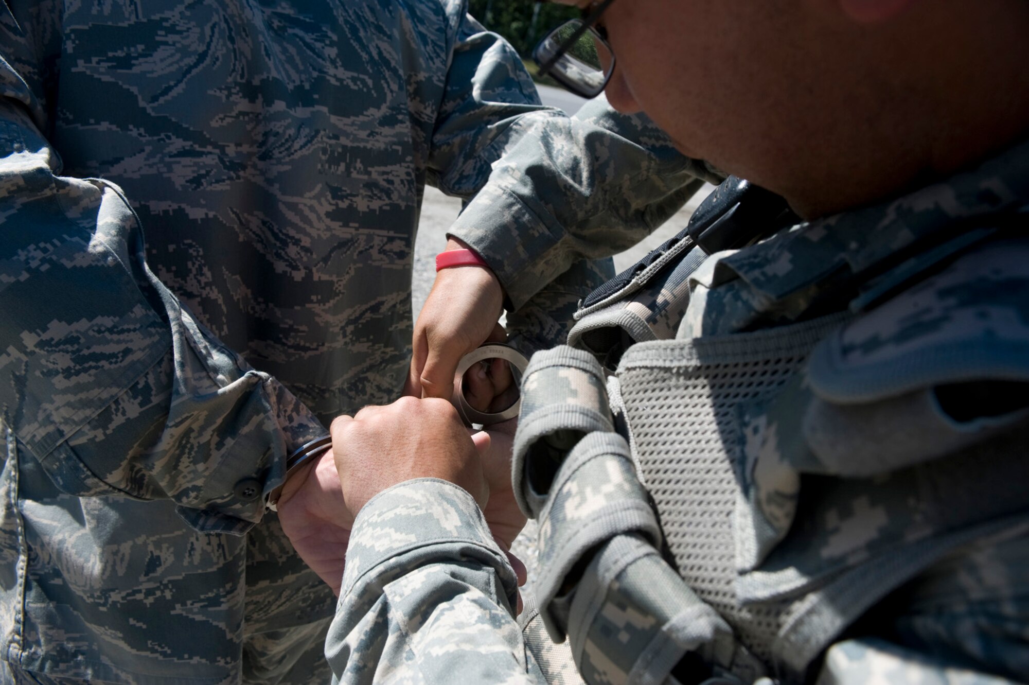 EIELSON AIR FORCE BASE, Alaska --An Airman from the 354th Security Forces Squadron hand cuffs Master Sgt. Brian Fairchild, 354th Medical Operations Squadron, after "failing" multiple staged sobriety tests July 2, 2008. Sergeant Fairchild and members of the 354th Security Forces Squadron participated in a drinking a driving exercise to promote the awareness of the dangers and repercussions of drinking a driving. (U.S. Air Force photo by Airman 1st Class Christopher Griffin)(RELEASED)