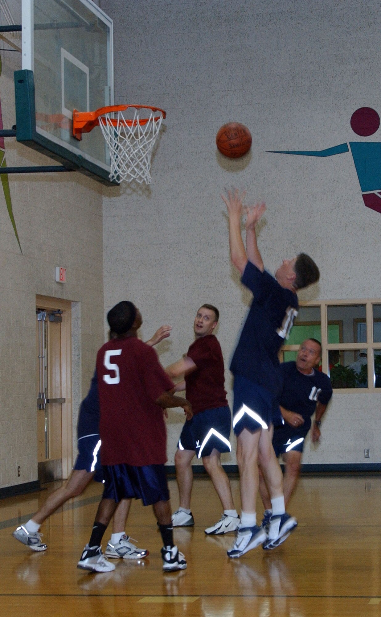 Col. Richard A. Klumpp Jr., goes for a rebound during the Commander’s Challenge basketball game in the newly reopened Fitness Center gymnasium Wednesday, July 9, at Vance AFB, Okla. A new air conditioning system was installed to make physical fitness more comfortable for Team Vance. The final score was 38, commanders, and 44, base-population team. (U.S. Air Force photo by Joe B. Wiles)