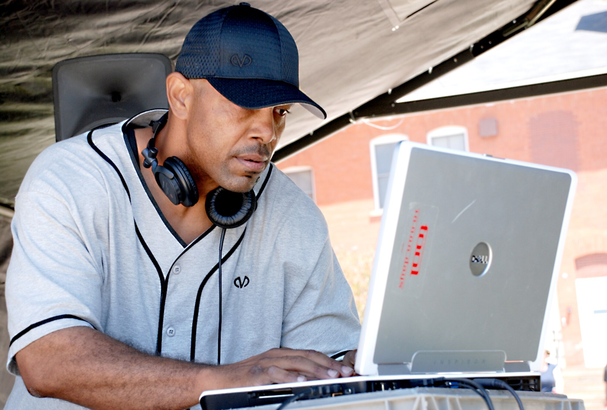 Disc jockey Roqone searches his laptop for music. DJ Roqone along with DJ Darina, both from Denver, Colo., provided the music for the Block Party June 20.