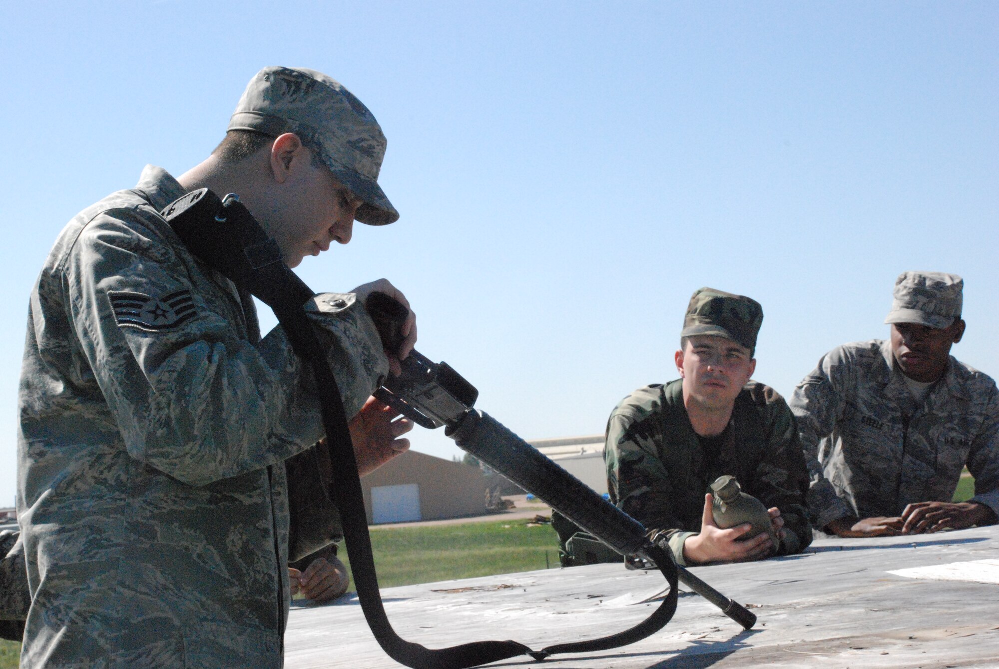 Staff Sgt. Justin Aguilar, 90th Security Support Squadron, instructs phase II exercise members the proper procedures for charging and clearing a weapon. The exercise began Monday and lasts until today (Photo by Airman 1st Class Daryl Knee).

