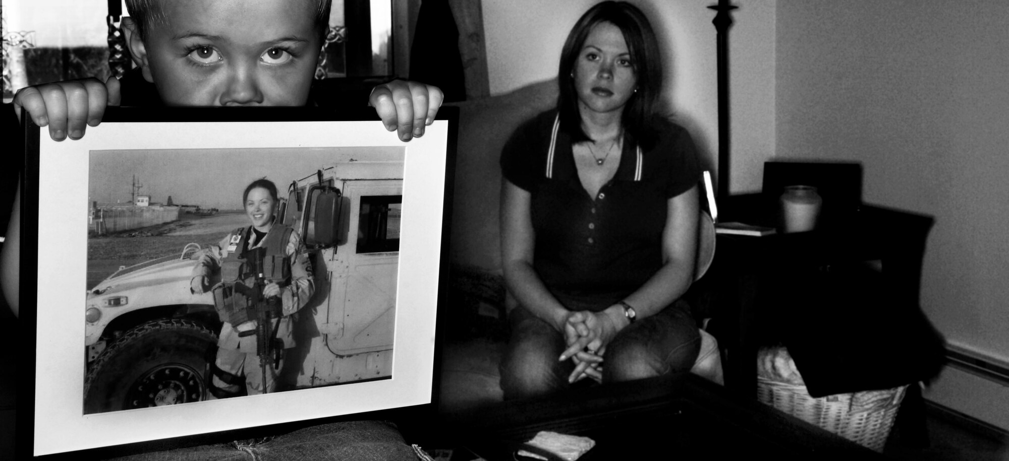 In today's Air Force many single parents, mostly mothers deploy in support of military operations all over the world.  Four year-old Aidan Robert Freeman displays a picture of his mother, Staff Sgt Samantha Freeman, that was taken during her recent six month deployment to Afganistan. Sergeant Freeman is a Flight Chief for the 354th Security Forces Squadron, Eielson Air Force Base, Alaska. (U.S. Air Force photo by Tech. Sgt. Eric T. Sheler)