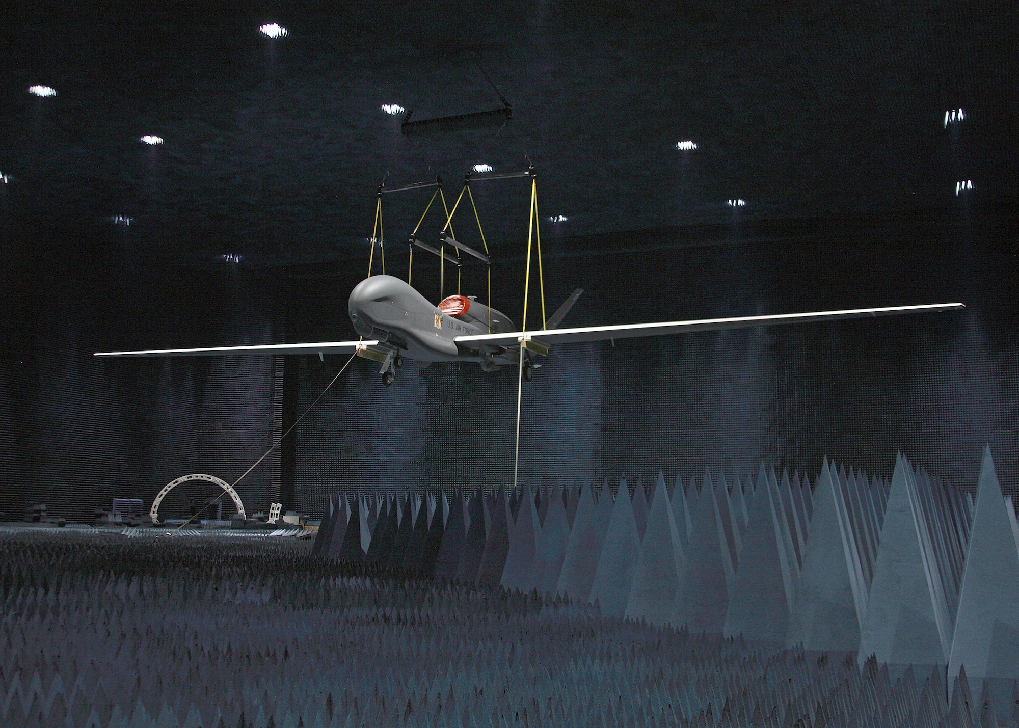 A full RQ-4 Global Hawk Block 20 aircraft hangs inside the Benefield Anechoic Facility here June 30 during electromagnetic profile testing. This is the first time a full Global Hawk aircraft was tested inside the anechoic facility. (Air Force photo by Jet Fabara)