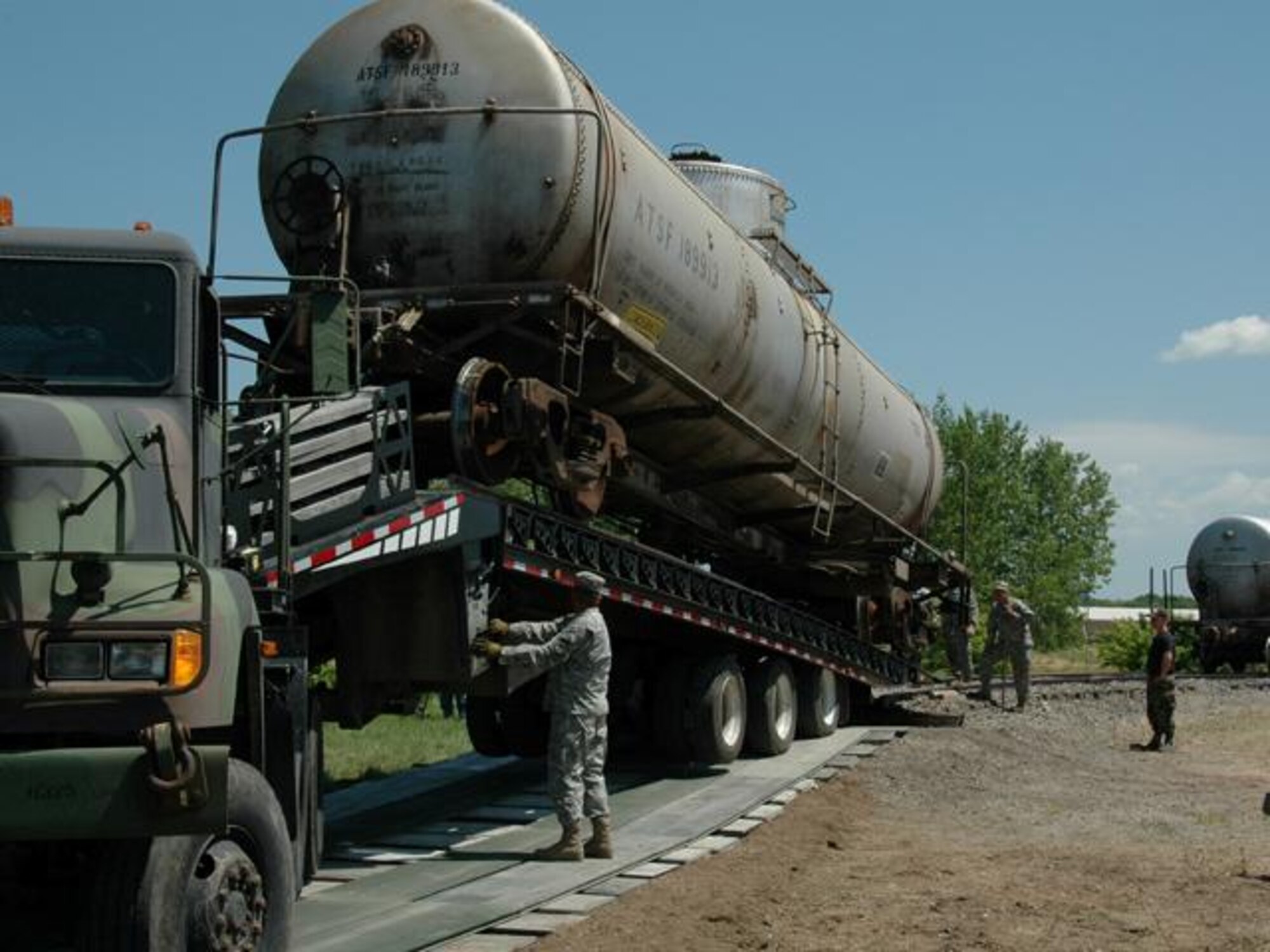 N.D. Air and Army National Guard members transfer a railcar from the Spur railroad track on the N.D. State University Campus in Fargo N.D. to a flatbed truck on Wed. Jul 9, 2008.  The two railcars, donated by Burlington Northern Santa Fe Railroad, will be used for training at the N.D. Air National Guard base.  
