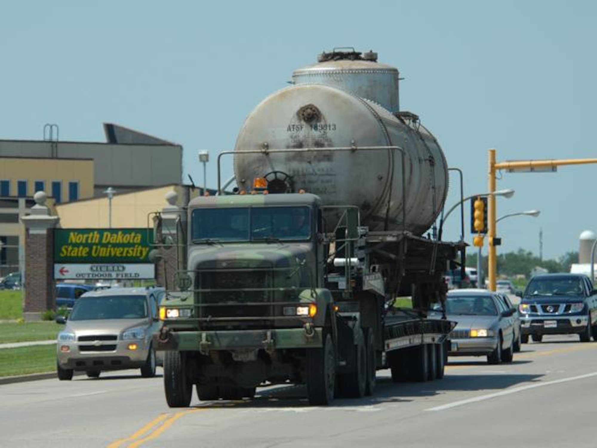 N.D. Air and Army National Guard members transport a railcar via a flatbed truck down 19th Ave. in Fargo N.D. on Wed. Jul 9, 2008.  Two railcars, donated by Burlington Northern Santa Fe Railroad, will be used for training at the N.D. Air National Guard base.  