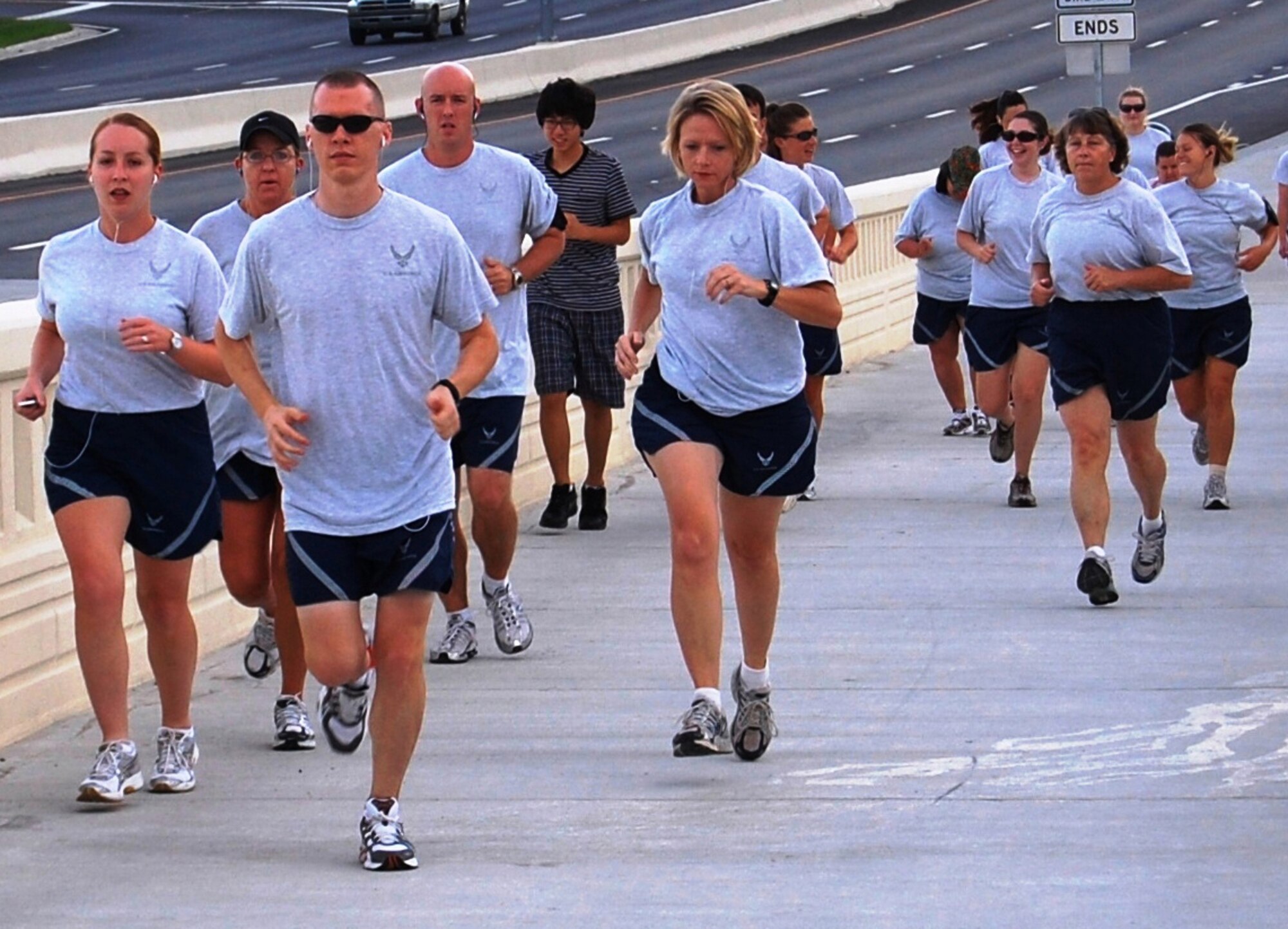 Members of the 81st Inpatient Operations Squadron begin their run across the Biloxi-Ocean Springs Bridge at 7 a.m. June 25.  Twenty-five people ran and walked to the Biloxi side and back across the 1.7-mile span.  When the bridge was rebuilt after Hurricane Katrina, a separate fitness lane was added.  Since its dedication Nov. 1, the span has gained popularity with runners, walkers and bicyclists.    According to Tech. Sgt. Jerry Dameron, noncommissioned officer-in-charge of the squadron’s critical care flight and one of the run organizers, the unit decided to run the bridge “to challenge our squadron to do more than the Air Force fitness test and get away from the routine 1.5-mile run.”  Twenty more squadron members opted to run at the Blake Fitness Center because of threatening weather.  (U.S. Air Force photo by Steve Pivnick)
