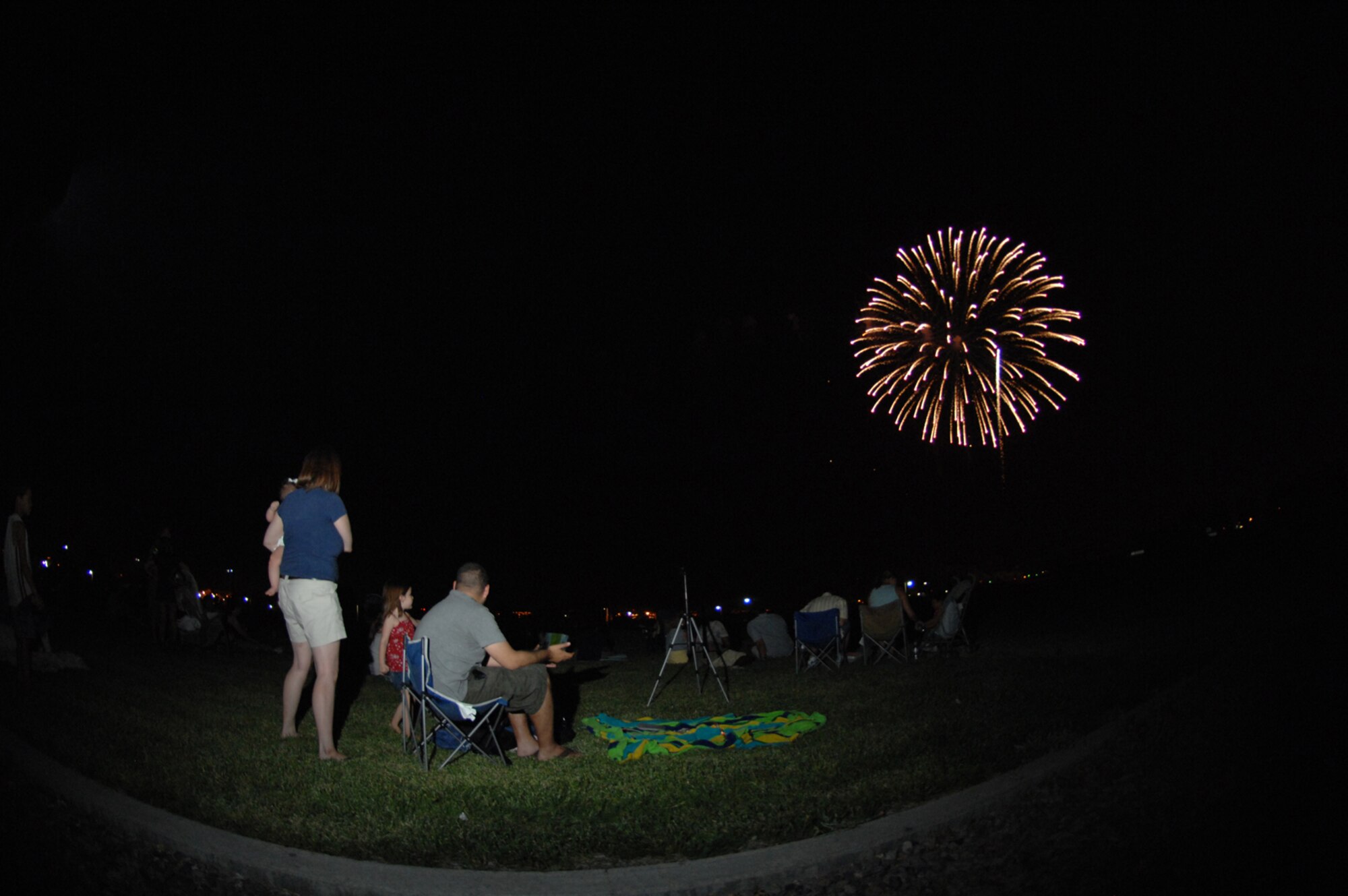 Family members observe the fireworks show during the Freedom fest event at Freedom park July 4, 2008 Nellis Air Force Base, Nev.
(U.S. Air Force Photo by Senior Airman Larry E. Reid Jr.)