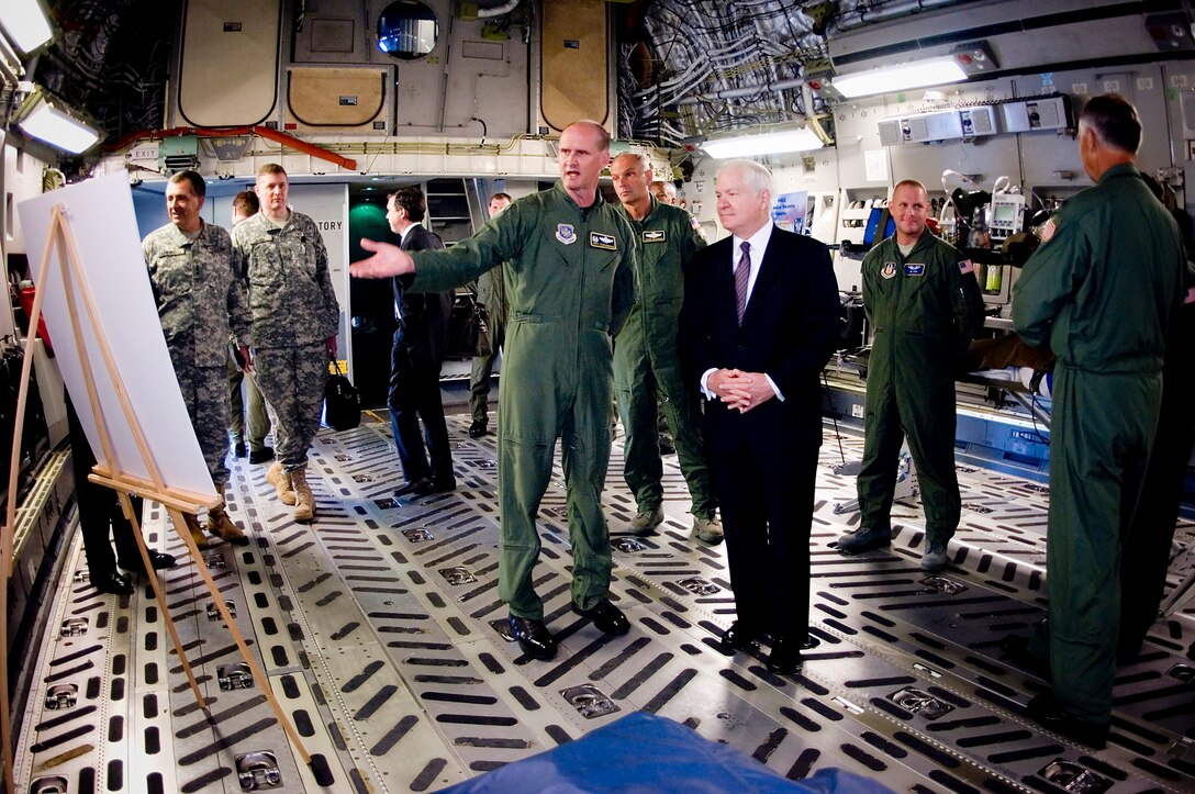 Col. Jeffrey Stephenson conducts a mission brief for Secretary of Defense Robert M. Gates during a static display tour inside a C-17 Globemaster III here July 7. Colonel Stephenson is the 62nd Airlift Wing commander. (U.S. Air Force photo/Abner Guzman)
