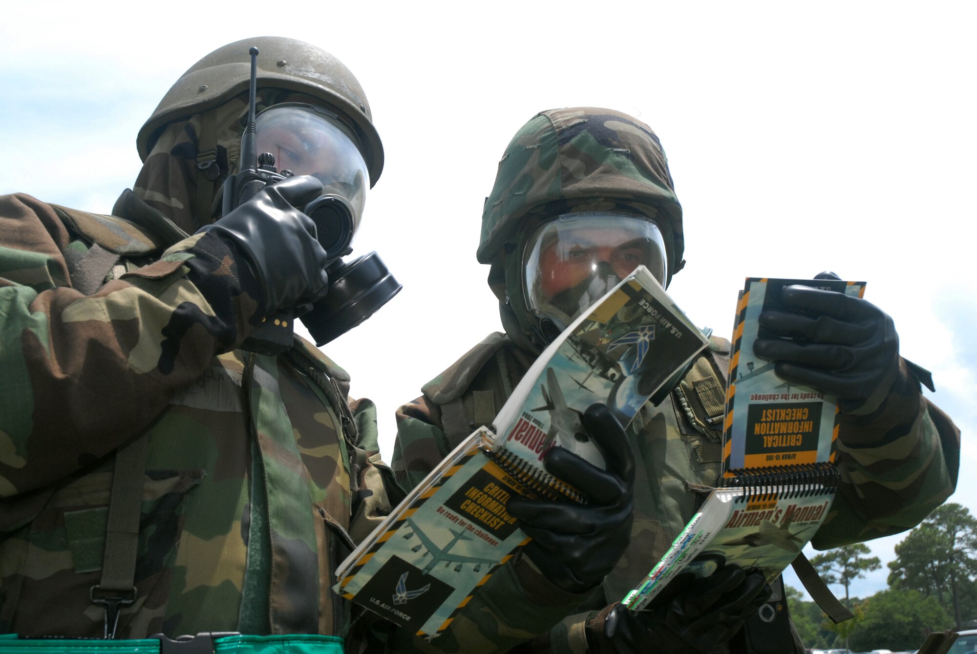 Airman 1st Class Jacob Lurvey, left and Airman 1st Class Matthew Baldyga, right,  go through their Airman's Manual at Charleston AFB July 9.  Airmen across the base are participating in weekly exercises to prepare for the Headquarters Air Mobility Command operational readiness inspection in August.  Airmen Lurvey and Baldyga are ground radio technicians with the 437th Communications Squadron.  (U.S. Air Force photo/Staff Sgt. Jennifer Arredondo)