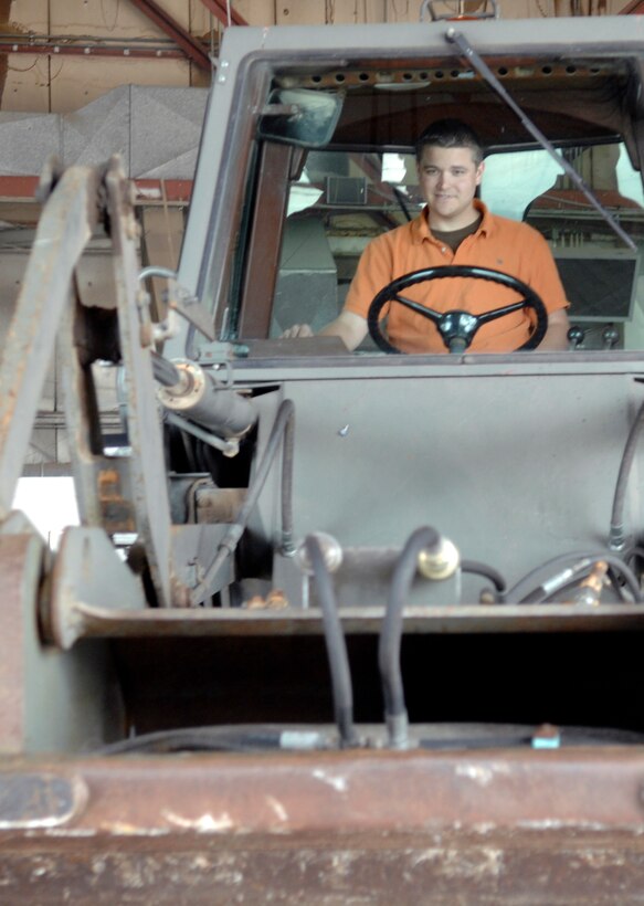 Luke Aadelen, husband of Senior Airman Jessica Aadelen, 28th Civil Engineer Squadron readiness and emergency management journeyman, learns the basic operations of a Front End Bucket Loader during the 28th CES Spouse Day at Ellsworth Air Force Base, S.D., July 3.  The event allowed spouses of Ellsworth members to learn about some of the different jobs within civil engineering. (U.S. Air Force photo/Airman Matthew Flynn)