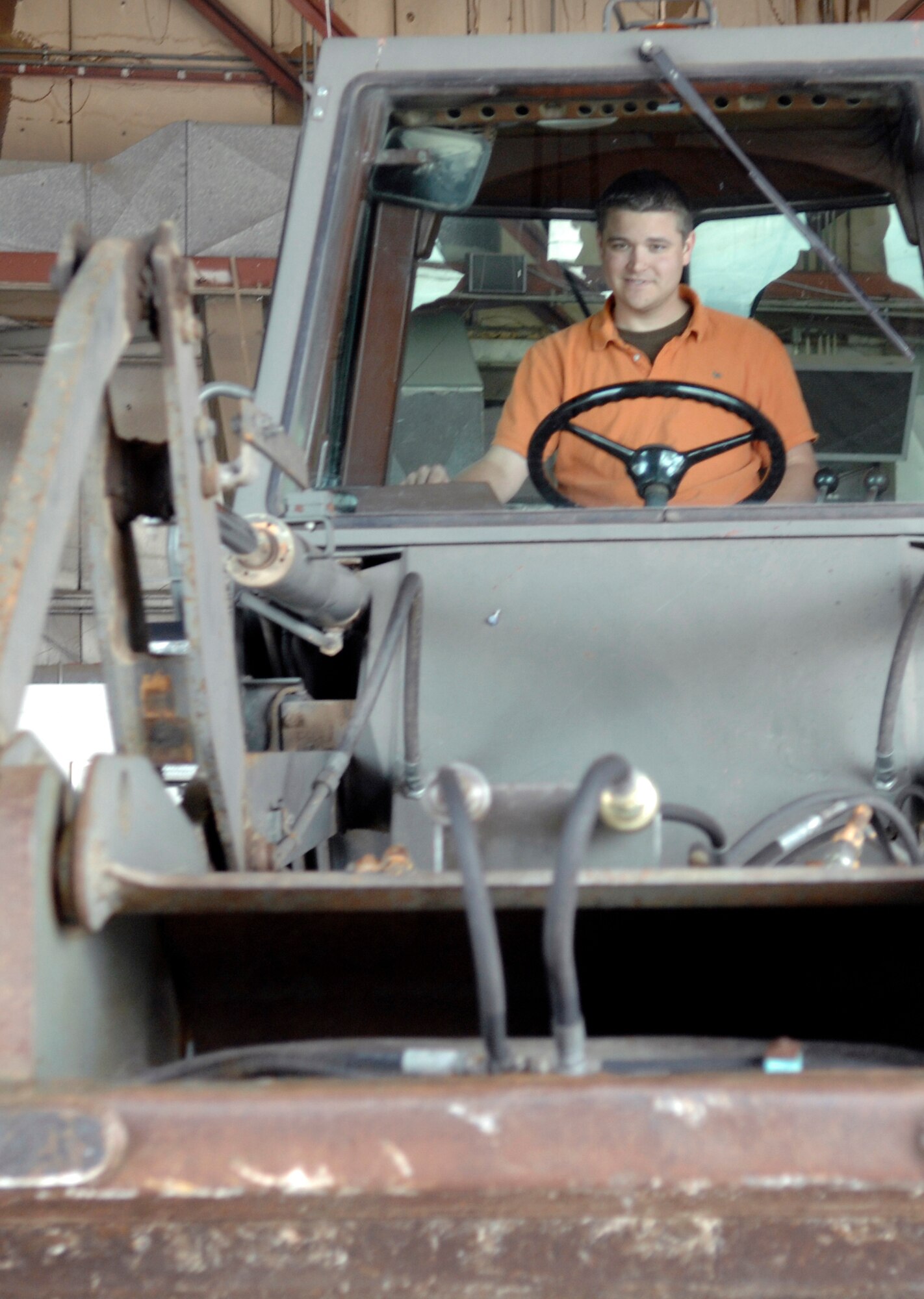 Luke Aadelen, husband of Senior Airman Jessica Aadelen, 28th Civil Engineer Squadron readiness and emergency management journeyman, learns the basic operations of a Front End Bucket Loader during the 28th CES Spouse Day at Ellsworth Air Force Base, S.D., July 3.  The event allowed spouses of Ellsworth members to learn about some of the different jobs within civil engineering. (U.S. Air Force photo/Airman Matthew Flynn)