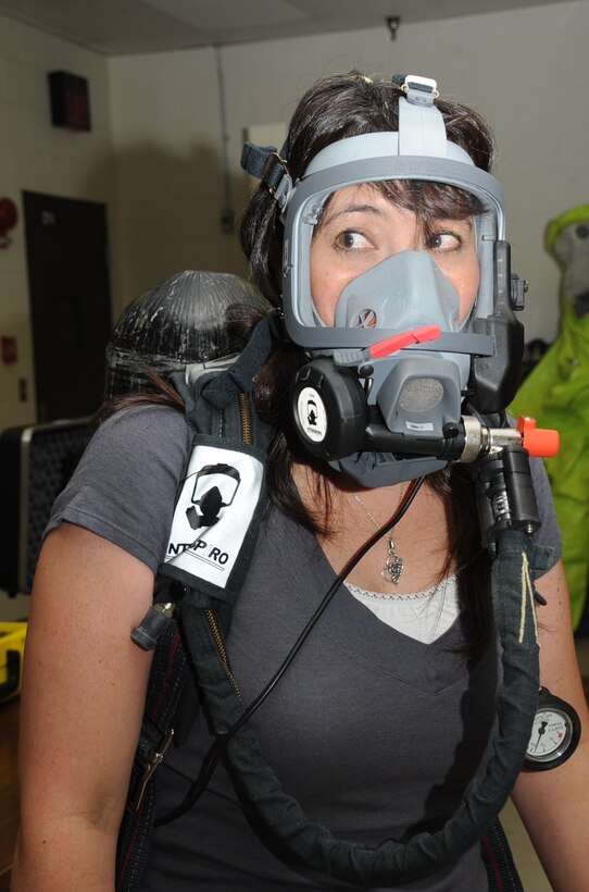 Sheryl Cronan, spouse of Chief Master Sgt. Robert Cronan 28th Civil Engineering Squadron superintendent, tests her breathing through an oxygen mask during 28th CES Spouse Day here July 3. All Airmen from 28th CES had the opportunity to show their spouses what they do in the Air Force. (U.S. Air Force photo/Senior Airman Anthony Sanchelli)