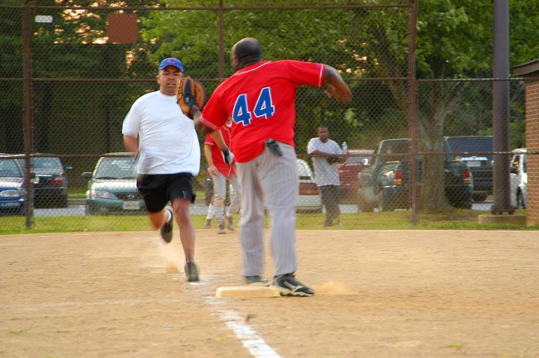 AFOSI Gators’ first baseman Gary King waits to tag out a runner at first. The Gators showed good defense limiting the opposition to 9 runs in the first contest. The Gators took two from the 89th Operations Group, 23-9 and 12-6 respectively, to up their record to 6-0. (U.S. Air Force photo/Tech. Sgt. John Jung)