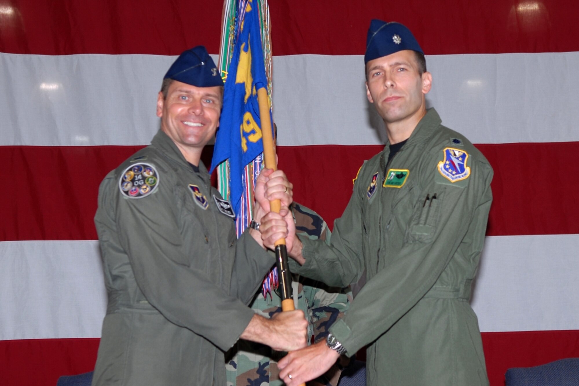 Colonel Eric Theisen, 14th Operations Group commander, passes the 49th Fighter Training Squadron guidon to Lt. Col. Tor Dietrichs in a ceremony July 3. Colonel Dietrichs replaces Lt. Col. Thomas Lennon as commander of the 49th FTS. (U.S. Air Force photo by Melissa Duncan)