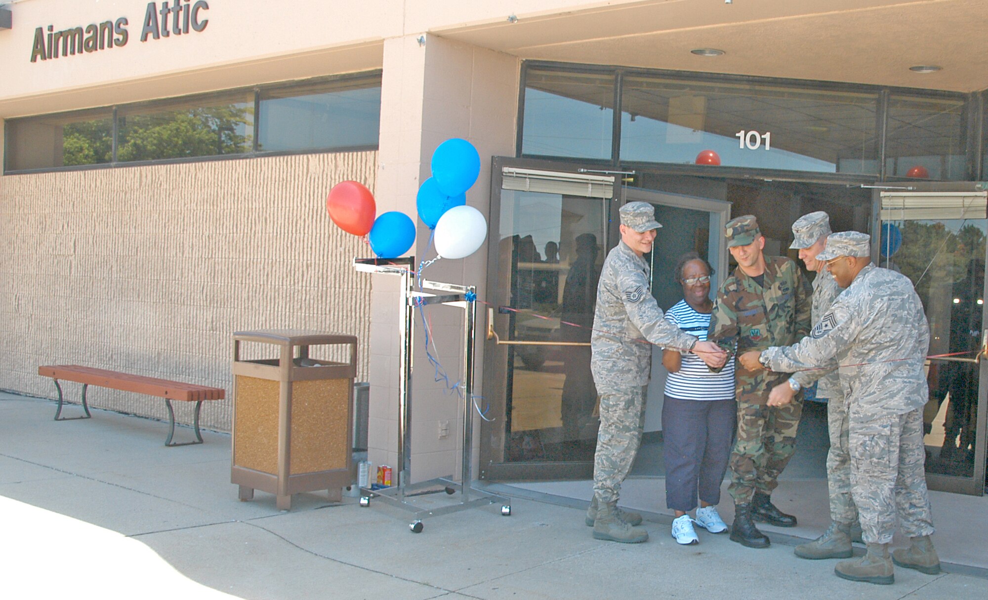 (From left to right) Tech Sgt. Eugene Skidmore, 55th Wing Command Post; Kristine Tate, Airman's Attic civilian volunteer; Master Sgt. Dominic Dumbra, 55th Force Support Squadron first sergeant; Col. Robert Maness, 55th Wing vice commander; and Chief Master Sgt. Kenneth Funderburg, 55th Wing command chief, commemorate the new location of the Airman's Attic with a ribbon cutting at the grand opening here July 2.   (Courtesy Photo)       
