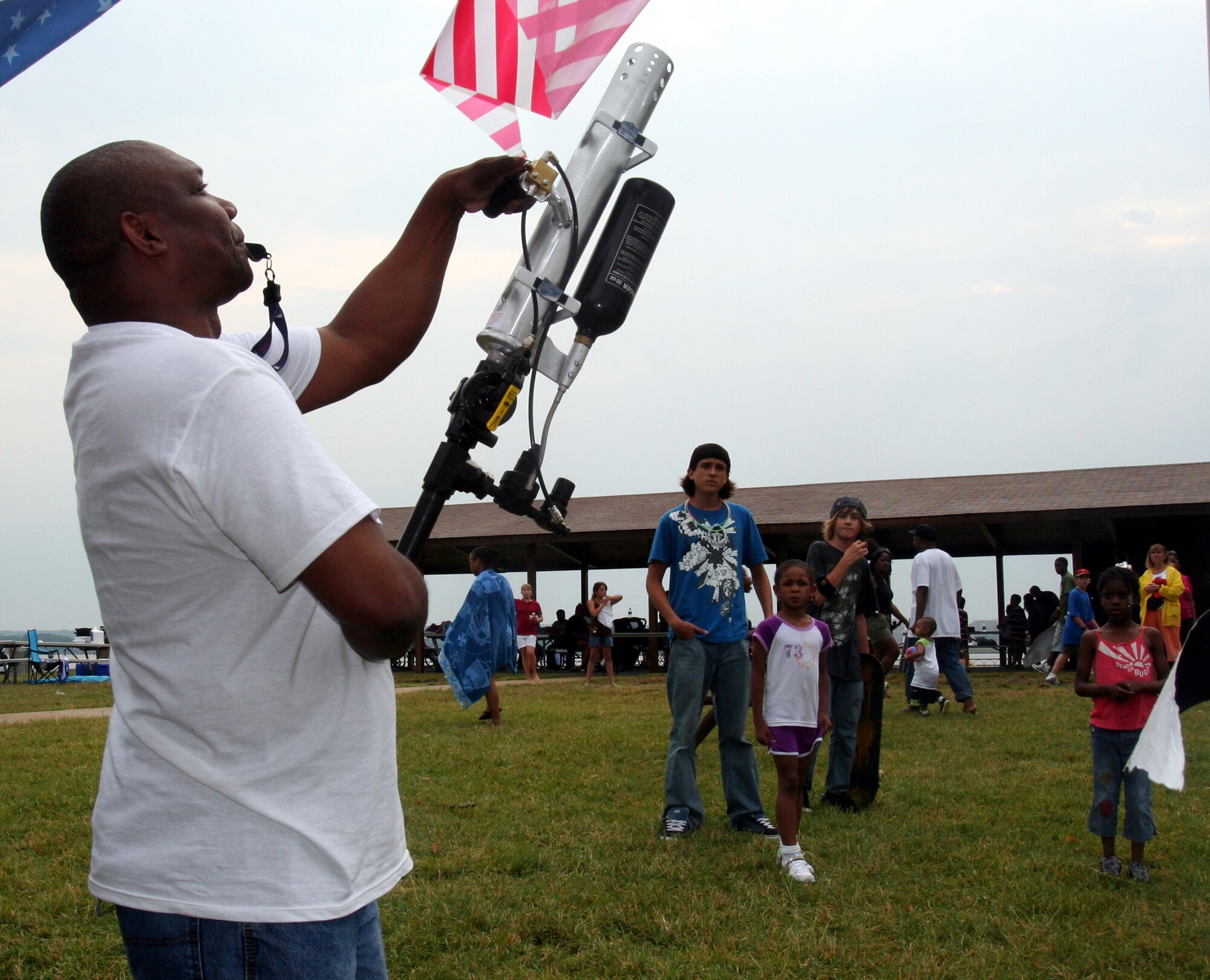 Donald "DC" Smith, 11th Services Division, uses an air cannon to launch a prize in the crowd July 4 during the 6th Annual Freedom Fest at Bolling Green Park. (U.S. Air Force photo by George Scott)