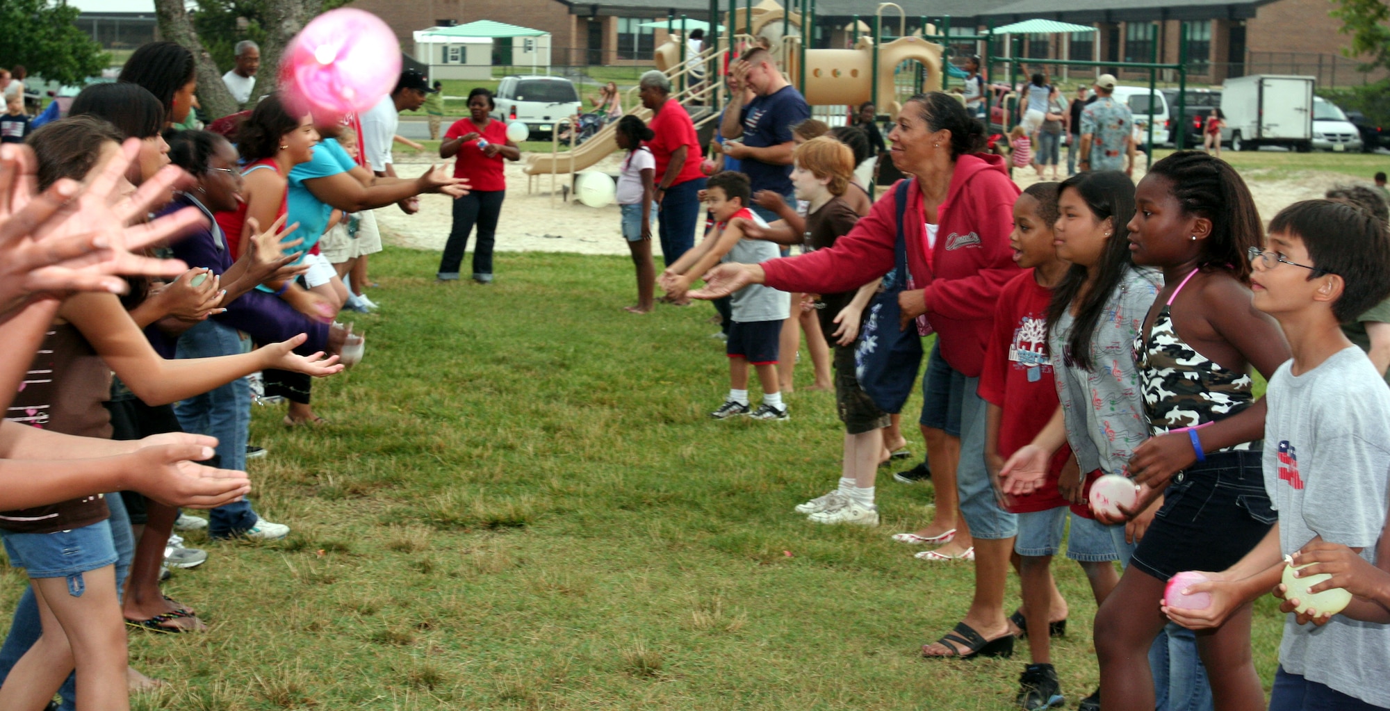 Members of the Bolling community participate in a water balloon toss July 4 during the 6th Annual Freedom Fest at Bolling Green Park. (U.S. Air Force photo by George Scott)