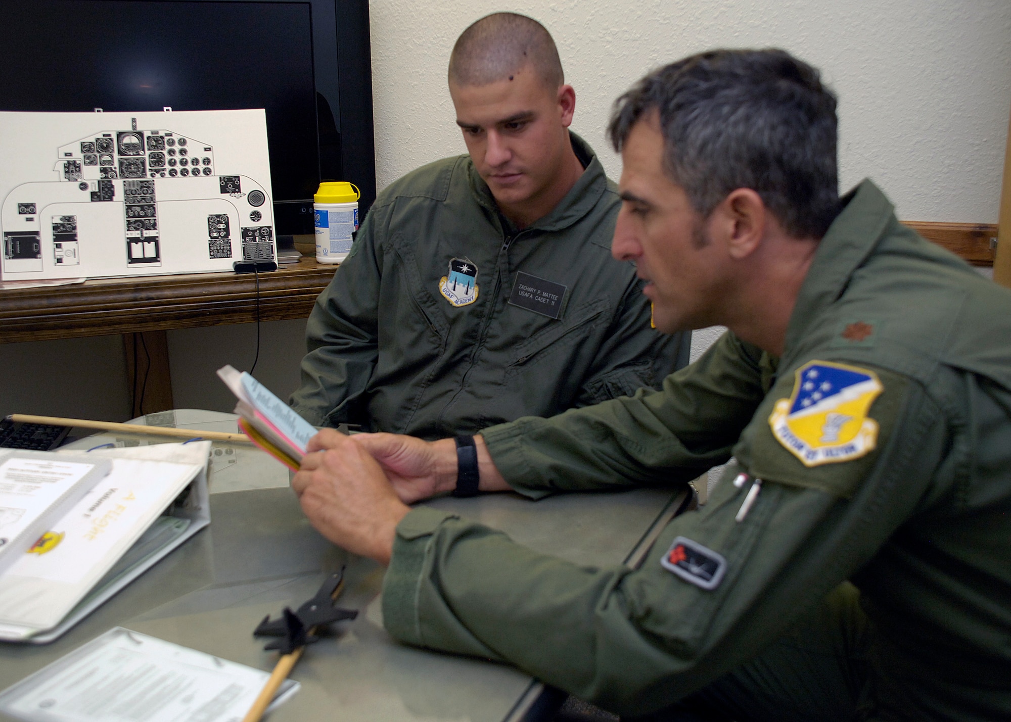 U.S. Air Force Academy Cadet Zach Mattee listens as Maj. Bret Carter, 49th Fighter Wing chief of F-22 Advanced Programs office, briefs him before his incentive flight at Holloman Air Force Base, N.M., July 2. Cadets visited Holloman as part of the Operations Air Force program to shadow officers and enlisted members and experience the active duty lifestyle. (U.S. Air Force photo/Airman 1st Class Michael Means)
