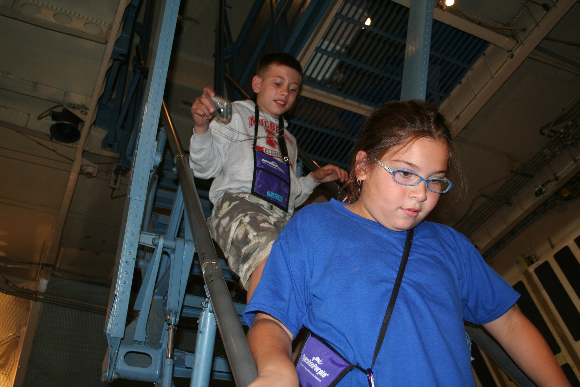 WRIGHT-PATTERSON AFB, Ohio - Elyssa Isaly and Aaron Bailey descend the ladder after touring the troop compartment of a 445th Airlift Wing C-5 Galaxy.  The children are part of a group from Operation Purple Summer Camp.  

In 2004, the Operation Purple® Summer Camp Program was created as a way to help military children struggling with having a parent deployed.  Due to the success of the camp program, it expanded and has hosted more than 10,000 military children who have or will experience deployment.  In 2008, there will be 100 weeks of camp held in 62 locations in 37 states and territories. 

These free, week-long, overnight camps are open to all military children. The program aims to help military kids experience carefree fun while also learning coping skills to deal with war-related stress and fostering relationships with others who know what they are going through. (U.S. Air Force photo/Laura Darden)


