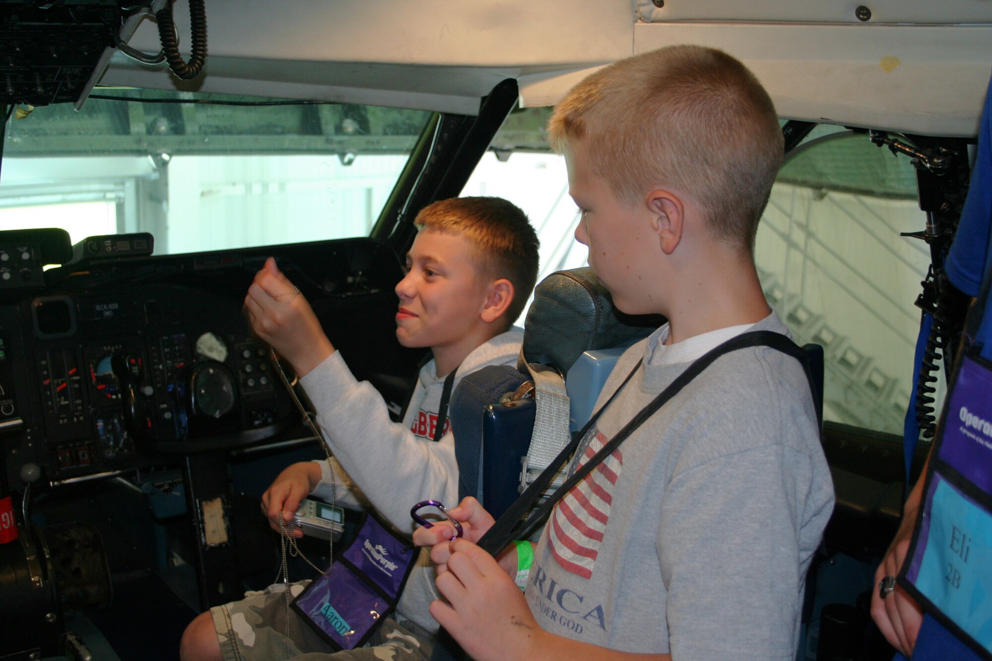 WRIGHT-PATTERSON AFB, Ohio - Aaron Bailey (left) and Drew Morgner (right) sit on the flight deck of a 445th Airlift Wing C-5 Galaxy during a tour for a group of children from Operation Purple Summer Camp.  

In 2004, the Operation Purple® Summer Camp Program was created as a way to help military children struggling with having a parent deployed.  Due to the success of the camp program, it expanded and has hosted more than 10,000 military children who have or will experience deployment.  In 2008, there will be 100 weeks of camp held in 62 locations in 37 states and territories. 

These free, week-long, overnight camps are open to all military children. The program aims to help military kids experience carefree fun while also learning coping skills to deal with war-related stress and fostering relationships with others who know what they are going through. (U.S. Air Force photo/Laura Darden)



