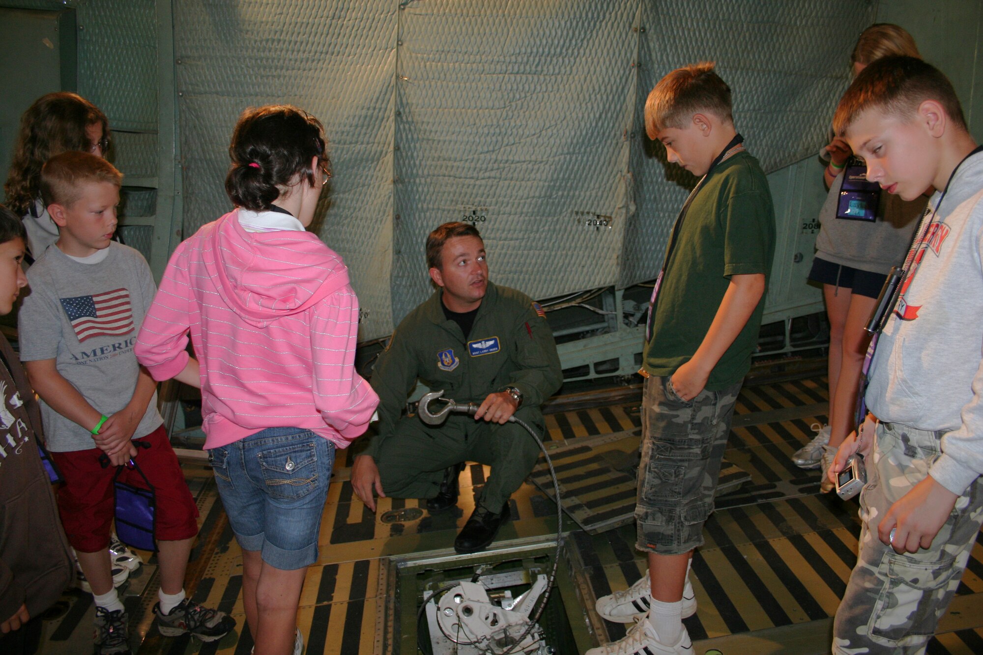 WRIGHT-PATTERSON AFB, Ohio - Master Sgt. Larry Unger, 89th Airlift Squadron, demonstrates a winch on one of the 445th Airlift Wing's  C-5 Galaxys during a tour for a group of children from Operation Purple Summer Camp.  

In 2004, the Operation Purple® Summer Camp Program was created as a way to help military children struggling with having a parent deployed.  Due to the success of the camp program, it expanded and has hosted more than 10,000 military children who have or will experience deployment.  In 2008, there will be 100 weeks of camp held in 62 locations in 37 states and territories. 

These free, week-long, overnight camps are open to all military children. The program aims to help military kids experience carefree fun while also learning coping skills to deal with war-related stress and fostering relationships with others who know what they are going through. (U.S. Air Force photo/Laura Darden)


